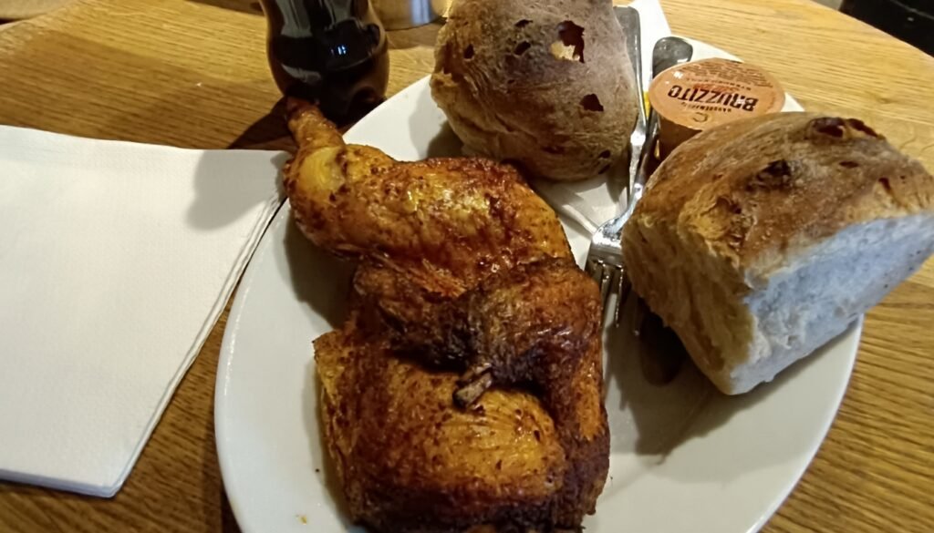 Roasted chicken leg served with artisan bread and butter on Sternen Grill restaurant